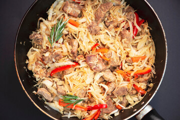 stewed cabbage with meat in a pan