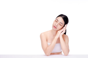 Beautiful natural woman looking at copy space, spa and wellness concept. Portrait of girl enjoying beauty treatment on white background. Carefree woman close her eyes  on her hands.