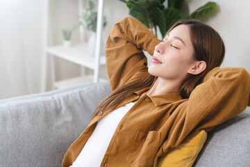 Young woman enjoying mind free moment relax and calm on the sofa at home.