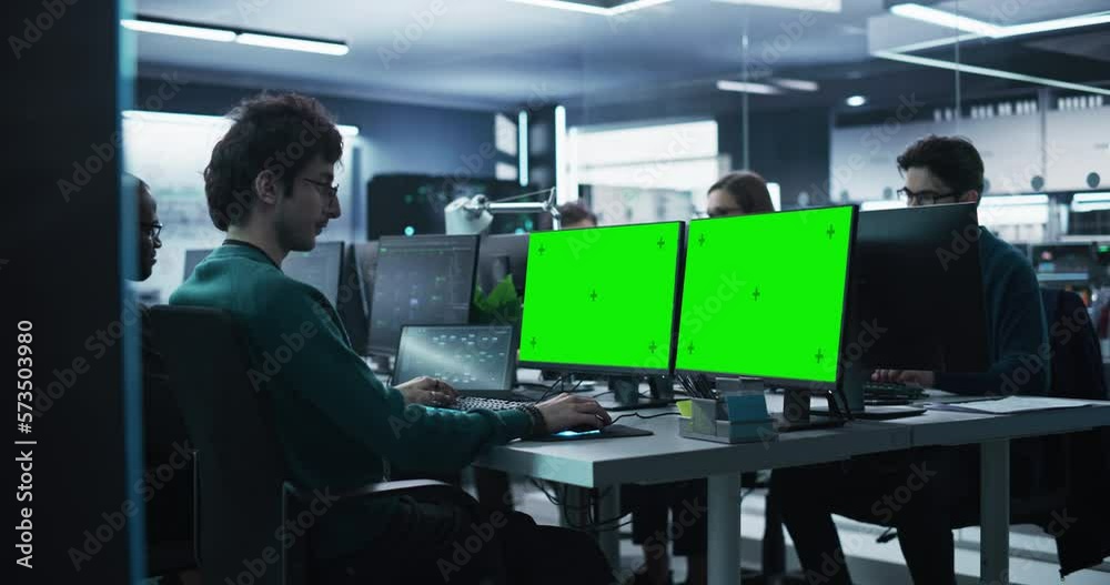Aufkleber Group of Diverse Multicultural Men and Women Working on Desktop Computers in a Research Center. Young Software Developer Working on a Computer with Two Green Screen Mock Up Displays