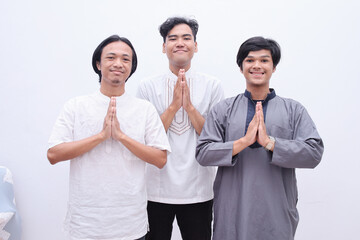 Muslim men showing greeting gesture and smiling to camera 