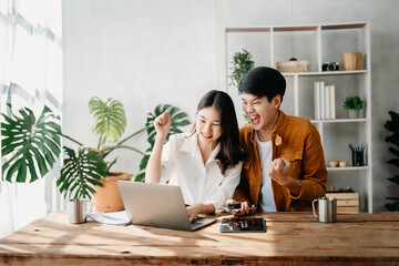 Young Asian business team creative businesspeople coworker, teamwork celebrating achievement and in planning design in creative in office.