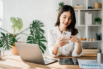  Working woman concept a female manager attending video conference and holding tablet, smatrphone and  cup of coffee in home office