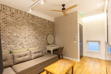 Naklejka na ściany i meble Interior of a modern hotel apartment with brick wall decoration