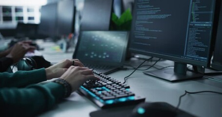 Close Up of a Software Developer Working on a Desktop Computer, Programming Code Running on Display. Specialist Typing on Keyboard, Coding and Implementing a Technical Feature, Working in an Agency - Powered by Adobe