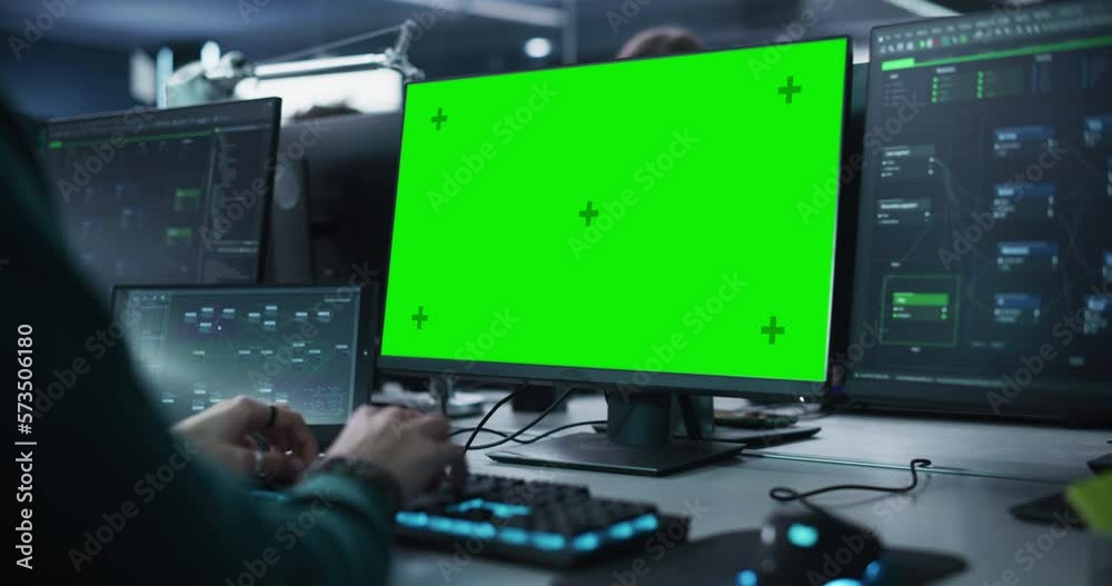 Leinwandbilder Close Up of a Software Developer Working on a Desktop Computer with Green Screen Mock Up Display. Specialist Typing on Keyboard, Coding and Implementing a New Technical Feature. Static Footage