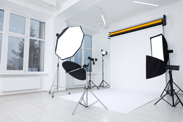 Fototapeta na wymiar Interior of modern photo studio with professional lighting equipment