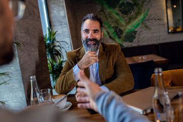 Two businessman having a business meeting in cafe.