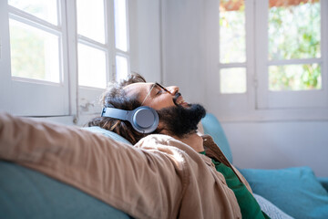 Relax man at home. Satisfied smiling young male resting after a hard day's work spending time alone