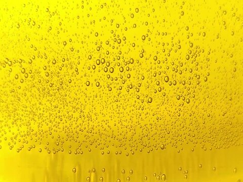 yellow carbonated drink beer small bubbles texture lemon juice cider sparkling soda water abstract background video