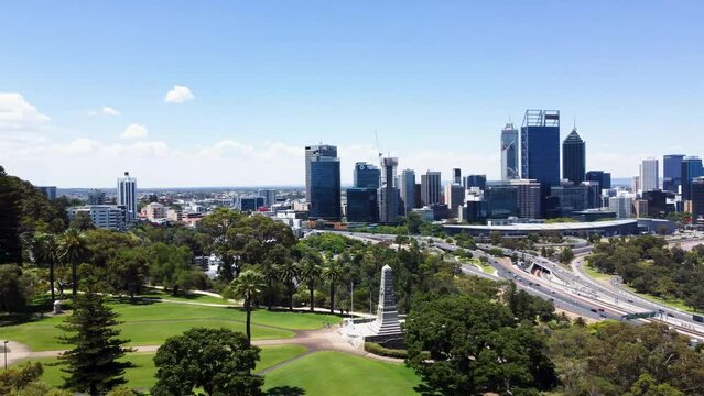 Rotating drone view of Perth's city skyline and King's Park Memorial on a sunny day (4K)