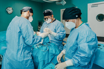 Medical doctors team operating patient in surgical room at hospital - Focus on center surgeon face