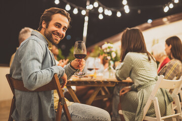 Family and friends celebrating at dinner on a rooftop terrace