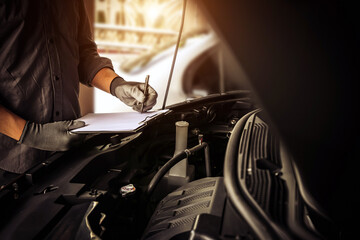 Close-up hand auto mechanic using the wrench to repairing car engine problem. Concepts of check and fix car and maintenance servicing.