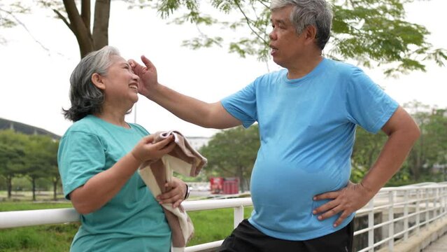 Happy and smile couples elderly asian rest after workout, jogging on morning, senior exercise outdoor for good healthy. Concept of healthcare and active lifestyle for healthy