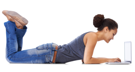 A young woman in 20s uses laptop lying on the floor with legs up, gazing enthusiastically at laptop screen or chatting on a dating app isolated on a PNG background.