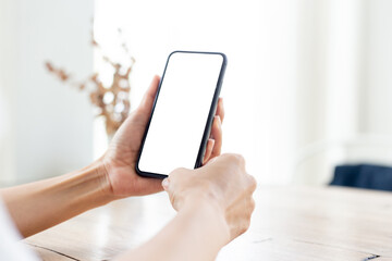 cell phone blank white screen mockup.hand holding texting using mobile on desk at office.background empty space for advertise.work people contact marketing business,technology