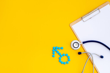 Male sign made of blue pills with doctor clipboard