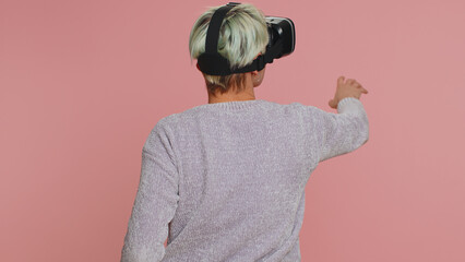 Woman using headset helmet to play simulation game app online. Watching virtual reality 3D 360...