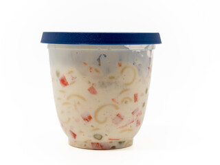 Vegetarian pasta salad in a plastic jar on a white background. Pasta salad Close-up.