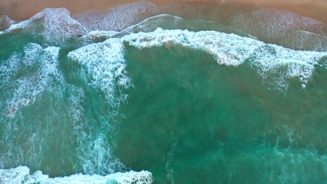 Stationary aerial top down drone shot of the beach and ocean riptide currents at Bondi beachAustralia