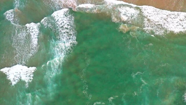 Moving aerial top down drone shot of the beach and ocean riptide currents at Bondi beach Australia