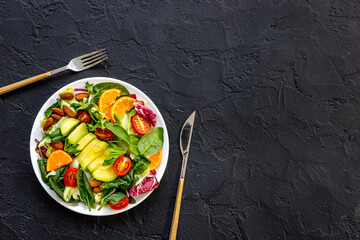 Bowl full of healthy vegetarian salad with avocado and tomatoes