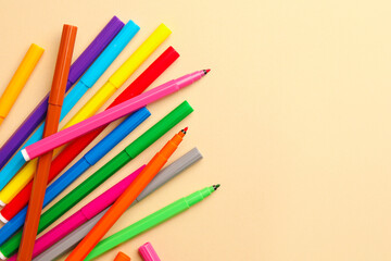 Fototapeta premium Many bright markers on beige background, flat lay. Space for text