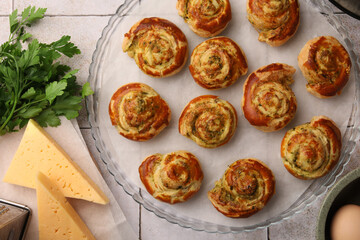 Fresh delicious puff pastry and ingredients on white tiled surface, flat lay