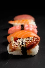 Fotobehang Delicious nigiri sushi on black table. Traditional Japanese cuisine © New Africa