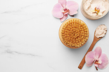 Flat lay composition with spa products and flowers on white marble table. Space for text