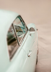 Pastel blue vintage car mirror on beige background, copy space
