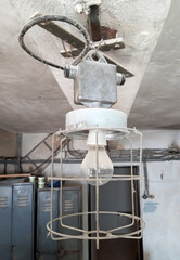 Old retro industrial light bulb in abandoned factory