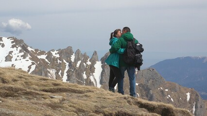 Couple kissing on top of the mountain