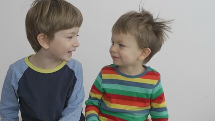 Little brothers smiling one to each other