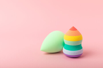Beauty blender. Colorful beauty sponges on a pink background. Cosmetic tool for applying foundation, concealer. Place for text. Place to copy.