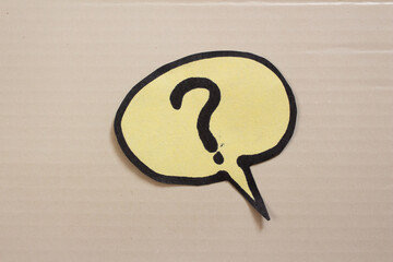 Question mark drawn on paper speech bubble. Curiosity and uncertainty concepts.