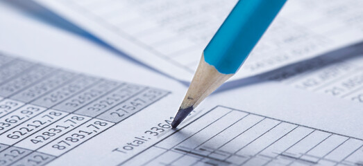 Checking the value of securities. Pencil, share listing and checking financial chart. Concept of banking, financial report and financial audit.