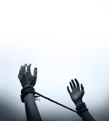 Tied hands raised to the sky