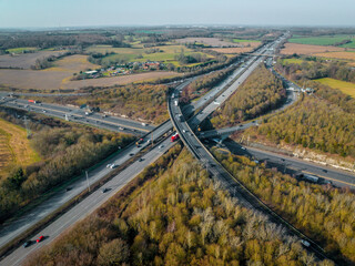 Vehicles Driving Along a Busy Motorway Interchange in the UK Aerial View
