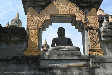The silhouette of the Buddha statue against the blue sky at the temple in Thailand