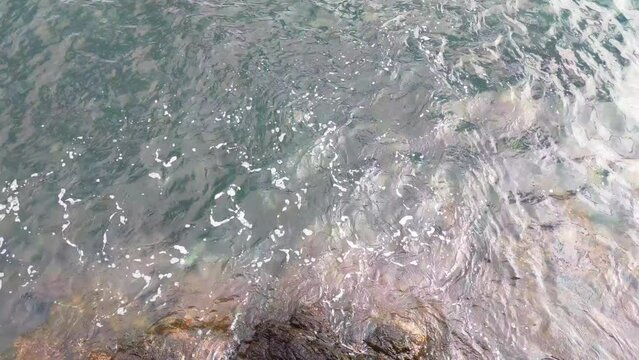 View from a height on the waves of the sea or ocean and rocks.
