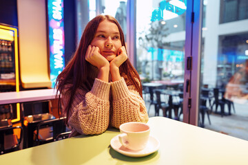 Stylish young woman drinking coffee at the coffee shop