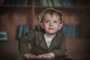 Portrait of a boy. Little gentleman. The boy smiles. Handsome little boy. Boy in a vintage suit. Boy in a cap. child in a hat