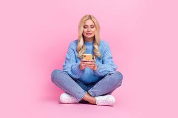 Obraz na płótnie Canvas Photo of lovely lady wear blue stylish clothes hold modern telephone write post repost share news isolated on pink color background