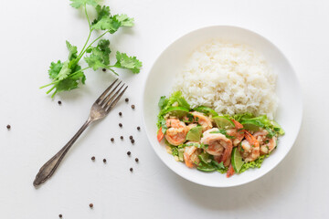 Healthy food stir fried shrimp lemon garlic and rice in bowl on white table.