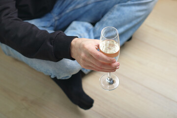 a person holds a glass with champagne
