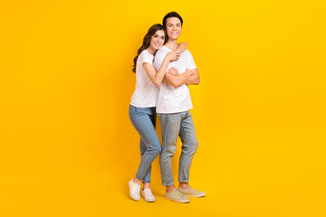 Full length photo of charming pretty husband wife dressed white t-shirts embracing smiling isolated yellow color background