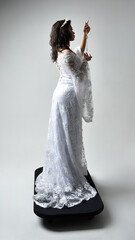 Full length portrait of beautiful woman wearing  fantasy costume, white bridal gown.  standing...