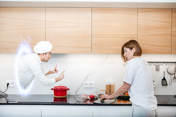 Woman cooks in the kitchen in a wrong way and suddenly appeared professional chef cooker helps her